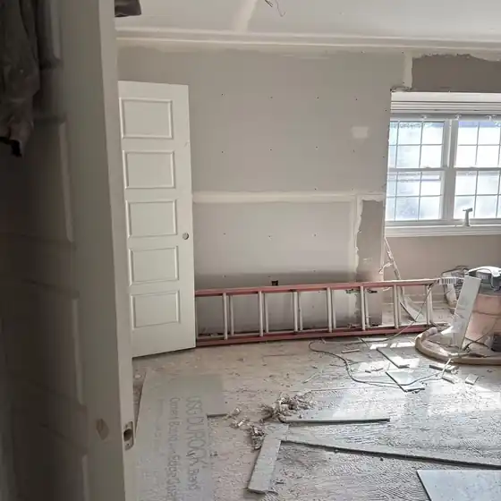 Interior remodel mid-drywall with a ladder and debris