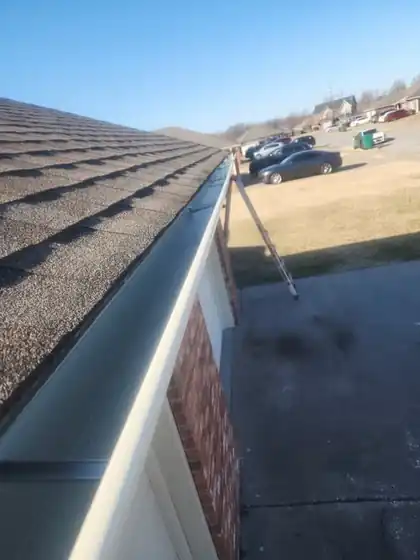New gutter run along a shingle roof edge